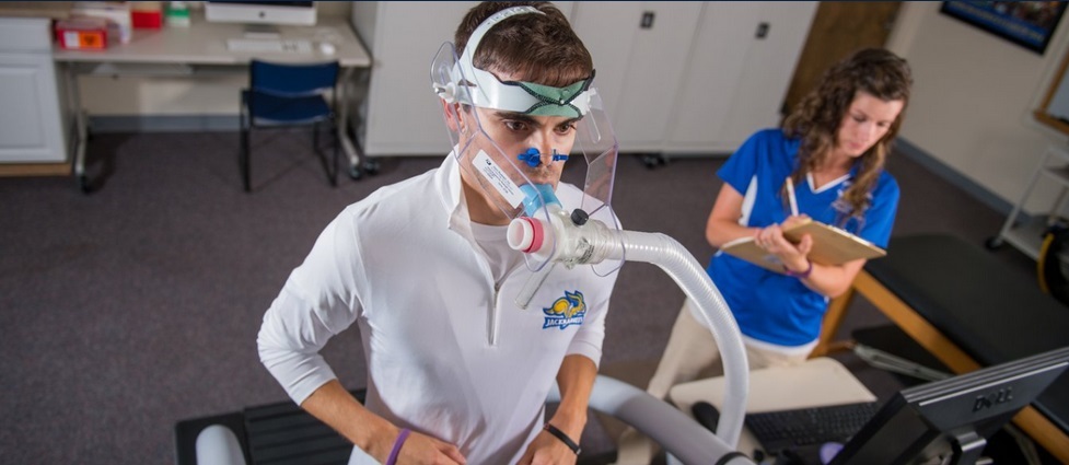 Male student runs on a treadmill.